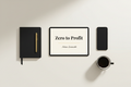 Zero to Profit ebook by Adrien Luciemable flat-lay with tablet, matte-black notebook, gold pen, smartphone and coffee cup on ivory background
